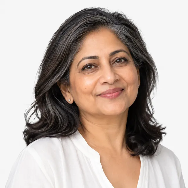 A smiling woman with long dark hair streaked with silver